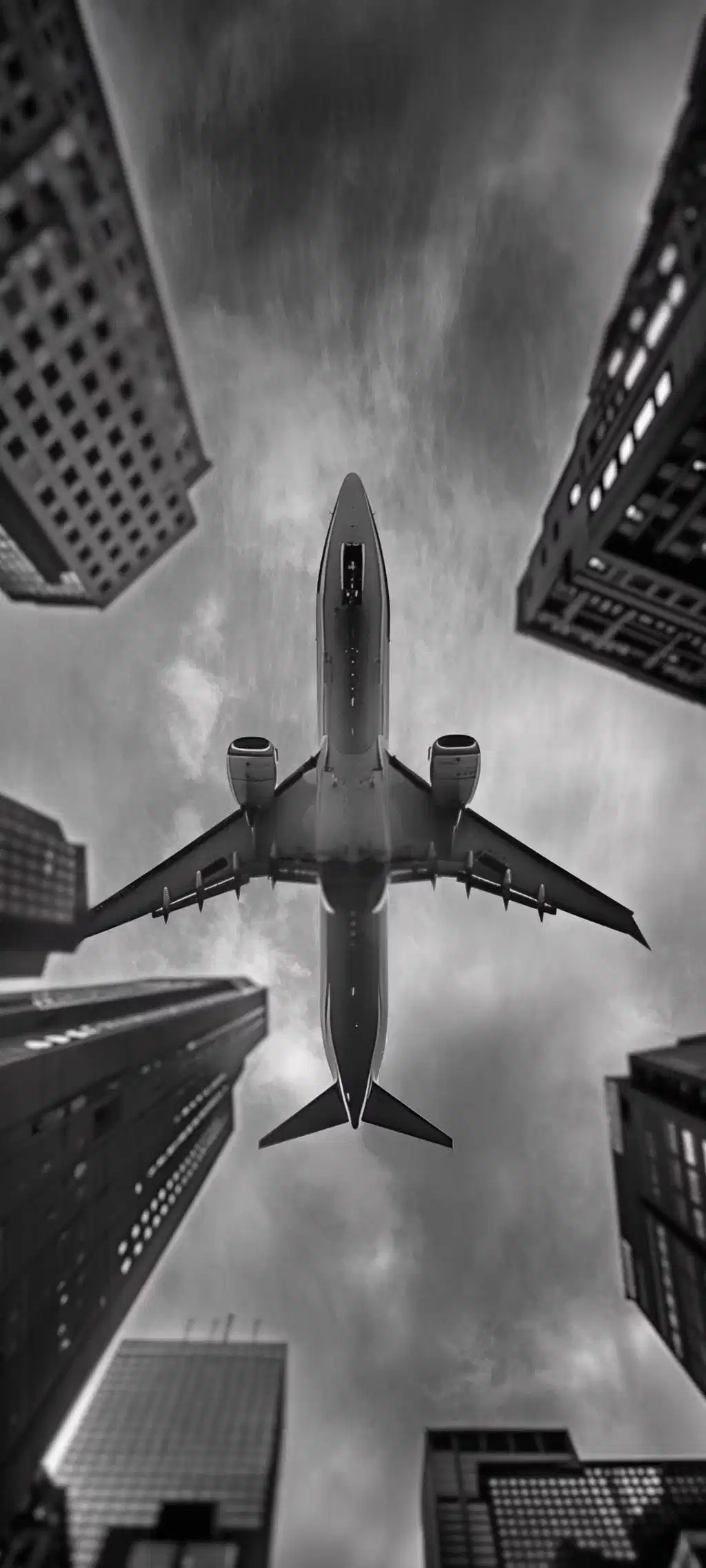 Airplane Flying Over Skyscrapers Monochrome